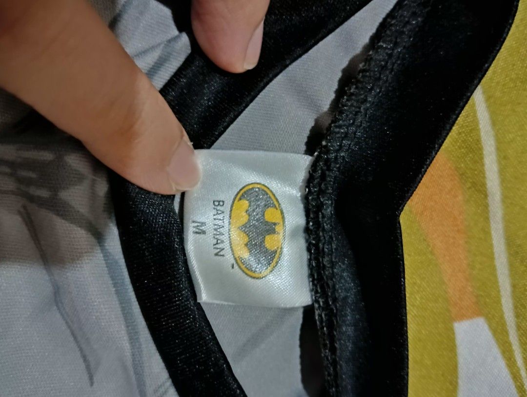 Batman Costume Set Size M (Category: Babies & Kids Fashion) located in Caloocan City. Submitted by mimieyahs_japanonlineshop (Listing ID 1467486151, Image 2). Description: - Official DC merchandise (2020) - Size: Medium (tag on collar) ages 4-5yrs old - Includes grey top and pants with printed chest logo - Accessories: Grey cape, black mask, boot covers, and gauntlets - Great for parties, Halloween, and dress-up events flaws on mask: nasira yung 