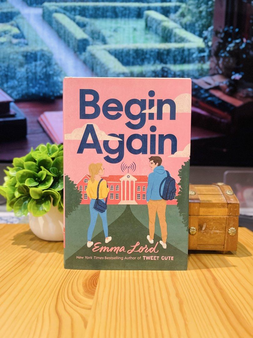 Begin Again by Emma Lord (Category: Storybooks) located in Makati City. Submitted by pagesandplay (Listing ID 1467551753, Image 1). Description: - Title: Begin Again - Author: Emma Lord - Publisher: Wednesday Books - Format: Hardcover - Cover Art: Pink and blue illustrated design featuring two characters - Condition: Clean white pages with minimal shelf wear on the edges - Genre: Young Adult (YA) contemporary romance.