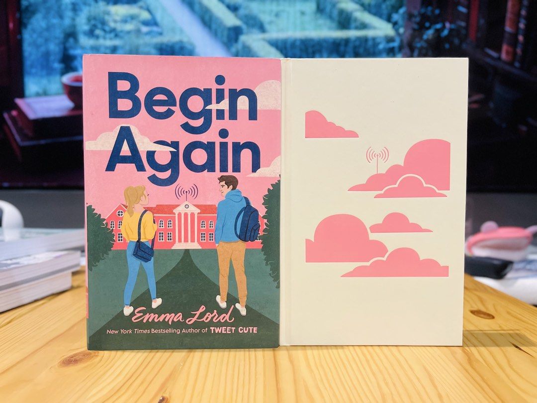 Begin Again by Emma Lord (Category: Storybooks) located in Makati City. Submitted by pagesandplay (Listing ID 1467551753, Image 2). Description: - Title: Begin Again - Author: Emma Lord - Publisher: Wednesday Books - Format: Hardcover - Cover Art: Pink and blue illustrated design featuring two characters - Condition: Clean white pages with minimal shelf wear on the edges - Genre: Young Adult (YA) contemporary romance.