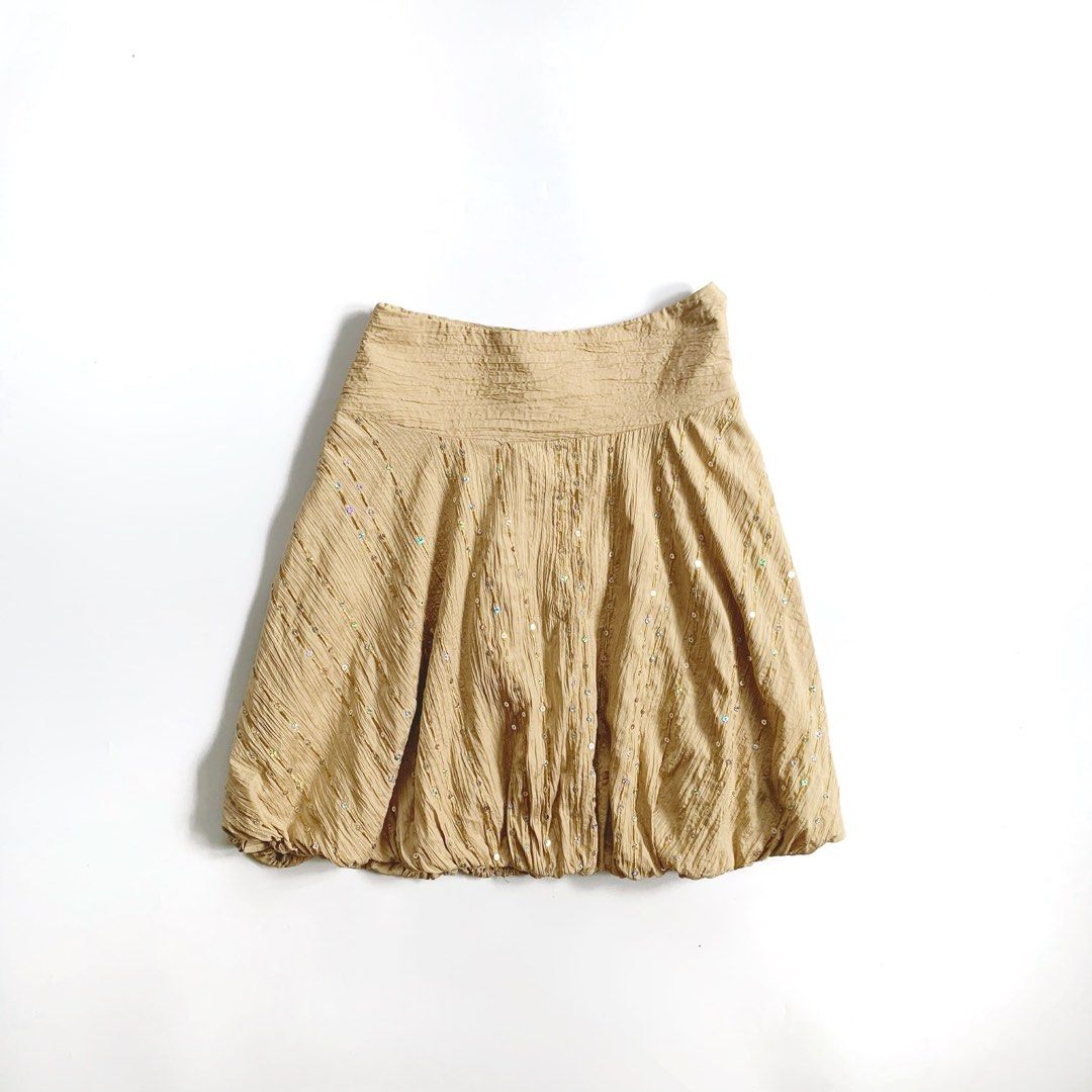 Beige bubble skirt with sequin details (Category: Skirts) located in Tarlac. Submitted by luv__vintage (Listing ID 1467461271, Image 2). Description: - Style: Fun vintage bubble hem skirt - Color/Texture: Beige with a unique crinkled texture - Details: Scattered shiny sequins along diagonal lines - Waistband: Wide elastic waistband for a comfortable hip fit - Perfect For: Parties, casual outings, or pairing with a simple white tube top W 24-25” L