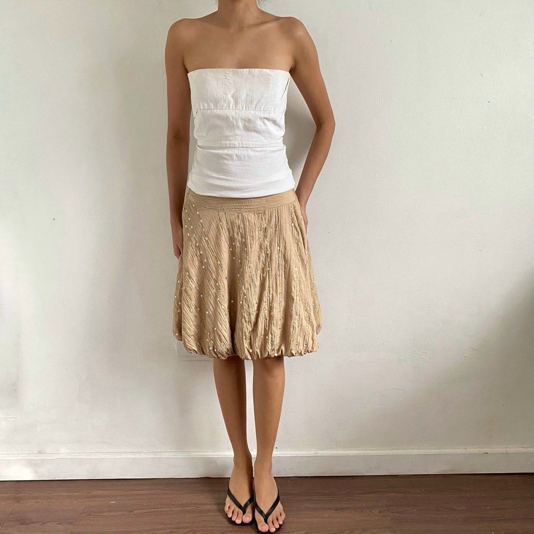 Beige bubble skirt with sequin details (Category: Skirts) located in Tarlac. Submitted by luv__vintage (Listing ID 1467461271, Image 1). Description: - Style: Fun vintage bubble hem skirt - Color/Texture: Beige with a unique crinkled texture - Details: Scattered shiny sequins along diagonal lines - Waistband: Wide elastic waistband for a comfortable hip fit - Perfect For: Parties, casual outings, or pairing with a simple white tube top W 24-25” L
