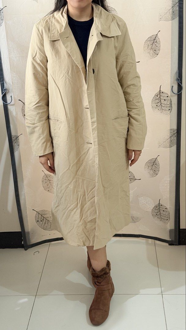 Beige Trench Coat for Autumn/Sprin (Category: Coats, Jackets and Outerwear) located in Paranaque City. Submitted by paupreloveditems (Listing ID 1467452059, Image 3). Description: - Best for autumn/spring - Size: L - Color: Neutral beige with contrasting black buttons and lining - Length: Midi style - Features: Button front closure, classic lapel collar, deep side pockets, and full black inner lining - Condition: Excellent - Perfect versatile out