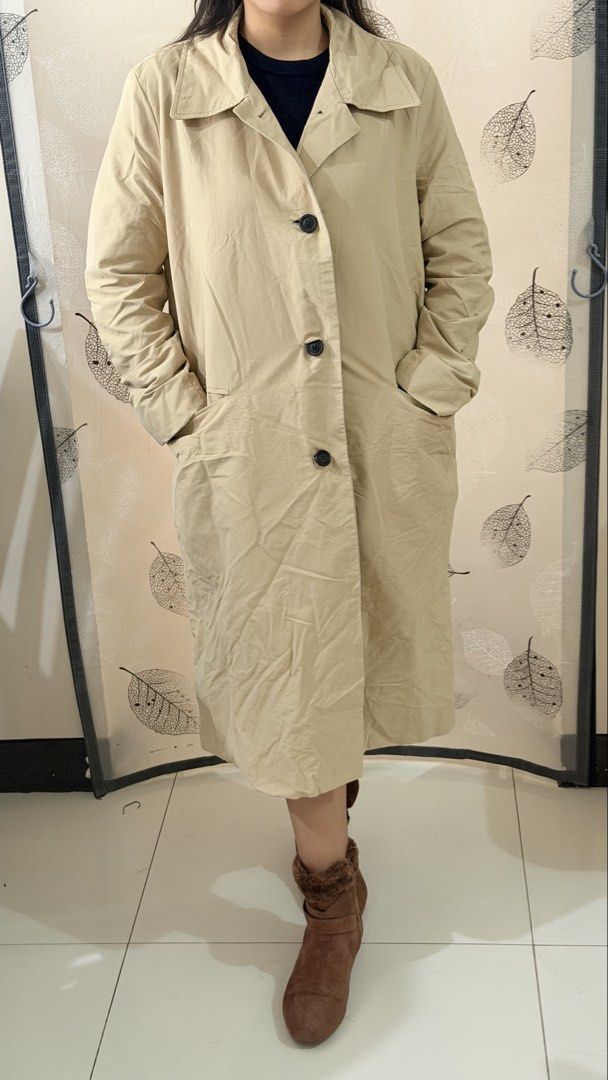 Beige Trench Coat for Autumn/Sprin (Category: Coats, Jackets and Outerwear) located in Paranaque City. Submitted by paupreloveditems (Listing ID 1467452059, Image 2). Description: - Best for autumn/spring - Size: L - Color: Neutral beige with contrasting black buttons and lining - Length: Midi style - Features: Button front closure, classic lapel collar, deep side pockets, and full black inner lining - Condition: Excellent - Perfect versatile out
