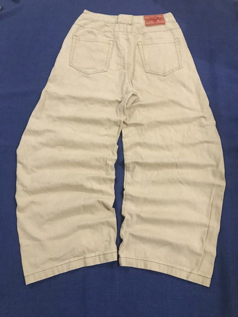Beige Wide Leg Cargo Pants (Category: Jeans) located in Manila. Submitted by its_d4ve (Listing ID 1467365123, Image 2). Description: - Color: Cream beige - Style: Casual streetwear, wide-leg with relaxed fit - Details: Front panel seams, classic belt loops, front button closure, and back patch pockets - Branding: Distinctive red brand patch near the back waistband - Condition: Brand new/Mint (Ready to wear for everyday outfits!).