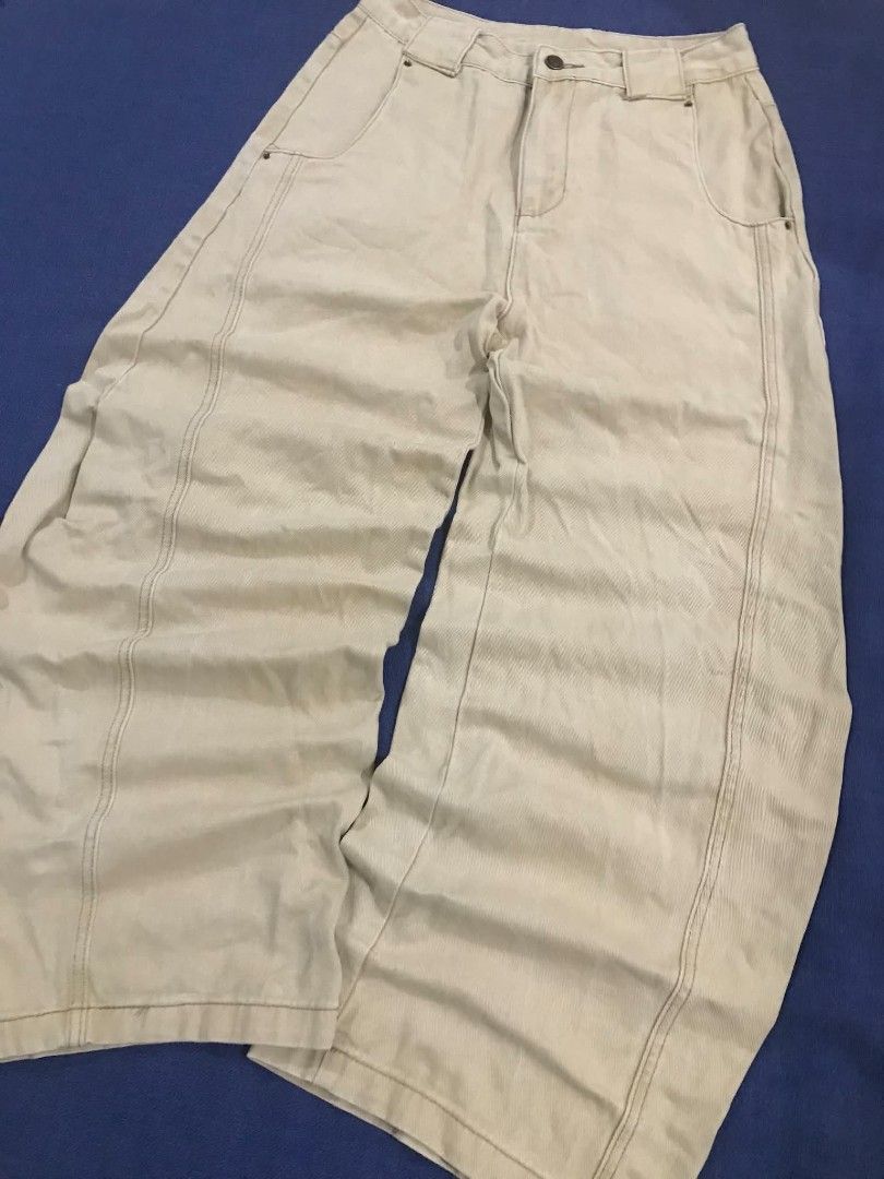 Beige Wide Leg Cargo Pants (Category: Jeans) located in Manila. Submitted by its_d4ve (Listing ID 1467365123, Image 3). Description: - Color: Cream beige - Style: Casual streetwear, wide-leg with relaxed fit - Details: Front panel seams, classic belt loops, front button closure, and back patch pockets - Branding: Distinctive red brand patch near the back waistband - Condition: Brand new/Mint (Ready to wear for everyday outfits!).