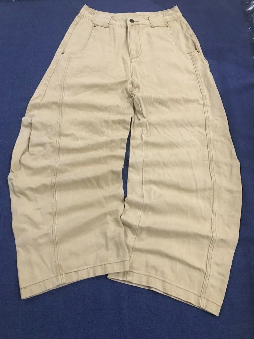 Beige Wide Leg Cargo Pants (Category: Jeans) located in Manila. Submitted by its_d4ve (Listing ID 1467365123, Image 1). Description: - Color: Cream beige - Style: Casual streetwear, wide-leg with relaxed fit - Details: Front panel seams, classic belt loops, front button closure, and back patch pockets - Branding: Distinctive red brand patch near the back waistband - Condition: Brand new/Mint (Ready to wear for everyday outfits!).