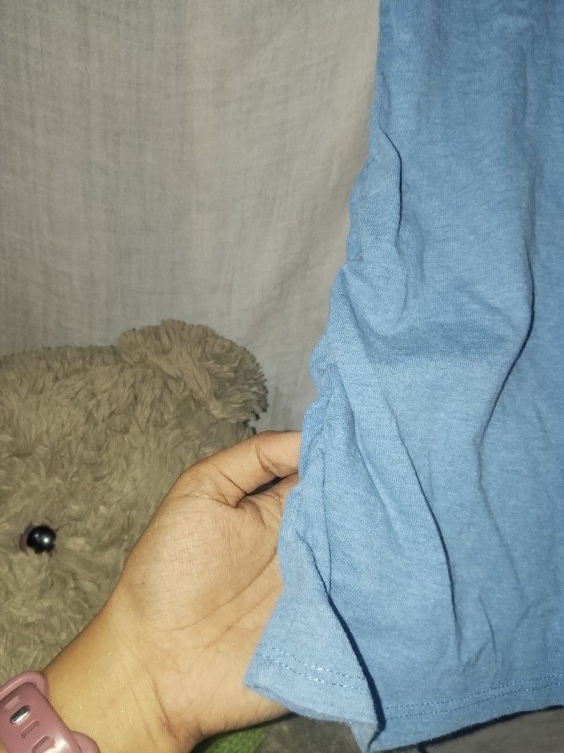 Bench light blue tee (Category: Blouses) located in Adams. Submitted by yelri555 (Listing ID 1467495928, Image 3). Description: Bench. Light Blue Tee - L ₱149 Details: - Brand: Bench. (Authentic / Legit) - Size: L on tag, fits S-L - Color: Light blue / Powder blue - Condition: 8.5/10 - has light stain (see photo), needs wash - Print: Bench. small logo -has side seam fit Note: Has minor washable stains on front.