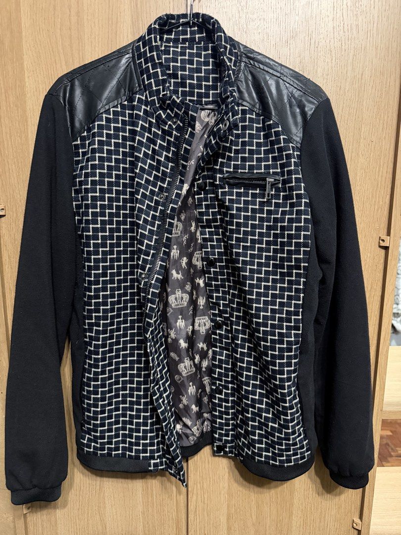 Black and Blue Patterned Jacket with Faux Leather Shoulders (Category: Coats, Jackets and Outerwear) located in Manila. Submitted by marclouiea70819 (Listing ID 1467562579, Image 1). Description: - Design: Black and blue geometric pattern with solid black sleeves - Details: Quilted faux leather panels on shoulders and back yoke, small chest zipper pocket - Closure: Zip-up front with snap buttons - Interior: Patterned grey lining with crown graphi