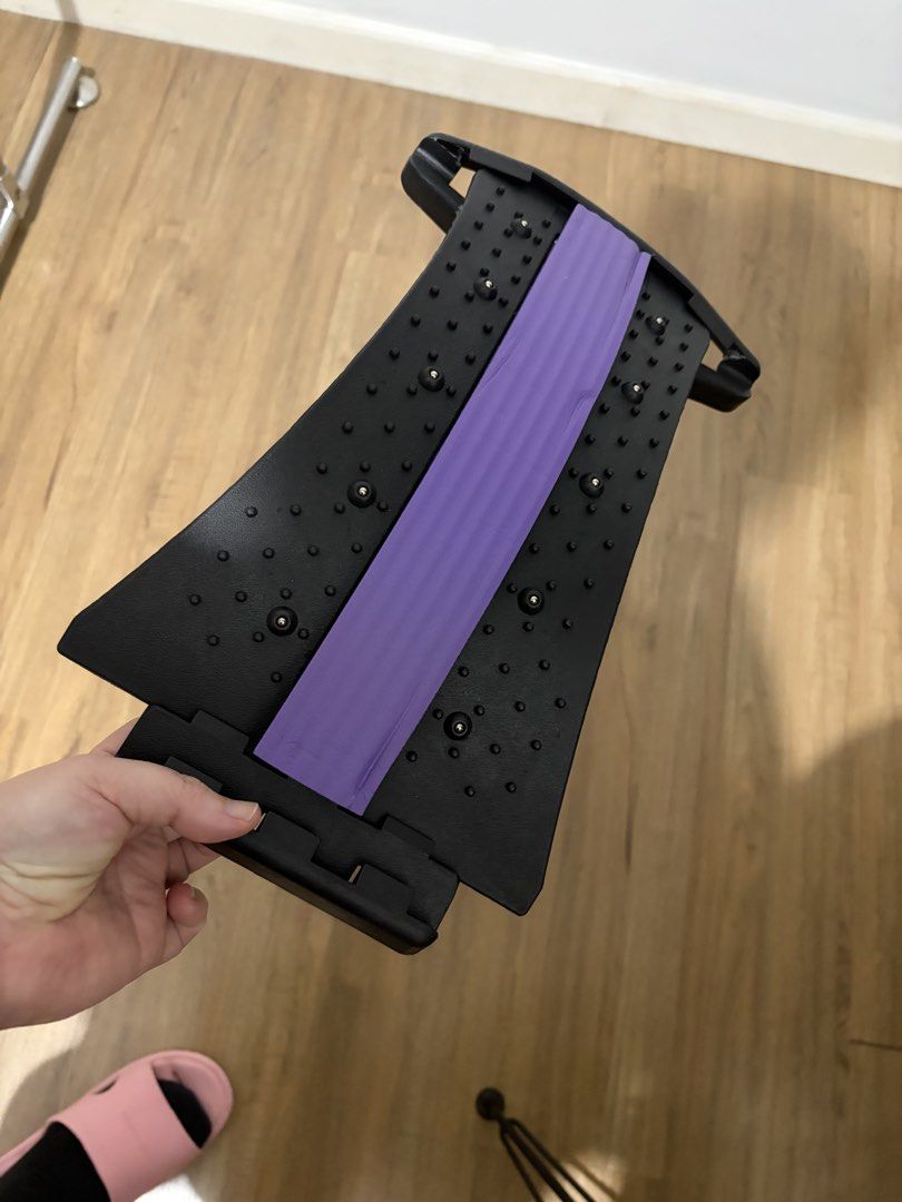 Black and Purple Back Stretcher Lumbar Support (Category: Braces, Support & Protection) located in Taguig. Submitted by boldowl.1ea607 (Listing ID 1467401688, Image 1). Description: - Material: Durable black plastic with a supportive purple foam cushion - Design: Adjustable arch with multiple slots, acupressure points, and massage knobs - Benefits: Provides back pain relief, posture correction, and spinal stretching - Usage: Ideal for daily home 