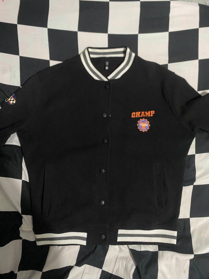 Black Champ Varsity Jacket (Category: Coats, Jackets and Outerwear) located in Binan City. Submitted by kaiz3nnnn_ (Listing ID 1467488142, Image 1). Description: - Color: Black - Embroidery: 'CHAMP' and team patch on the chest - Excellent condition - Mode of Payment: Gcash.