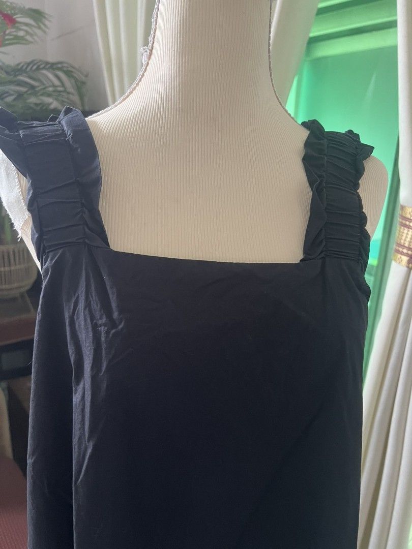 Black Dress with Ruffled Straps (Category: Dresses) located in Manila. Submitted by momshei123 (Listing ID 1467366704, Image 2). Description: - Color: Solid black - Design: Sleeveless with square neckline front and back - Details: Chic ruffled and shirred detailing on wide straps - Fit: Relaxed, loose, and lightweight - Length: Midi to knee-length (depending on height) - Versatility: Easy to throw on for casual days or dress up with accessories.