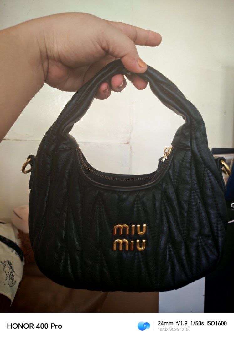 Black Miu Miu Quilted Leather Handbag (Category: Luxury Bags & Wallets) located in Manila. Submitted by cleverwhale_45b7bc (Listing ID 1467374907, Image 3). Description: - Brand: Miu Miu - Material: Premium black leather with chic quilted texture - Hardware: Elegant gold-tone accents with prominent front logo lettering - Closure: Secure top zip closure - Features: Short top handle & side D-rings (strap-ready) - Condition: Excellent / Well-maintai