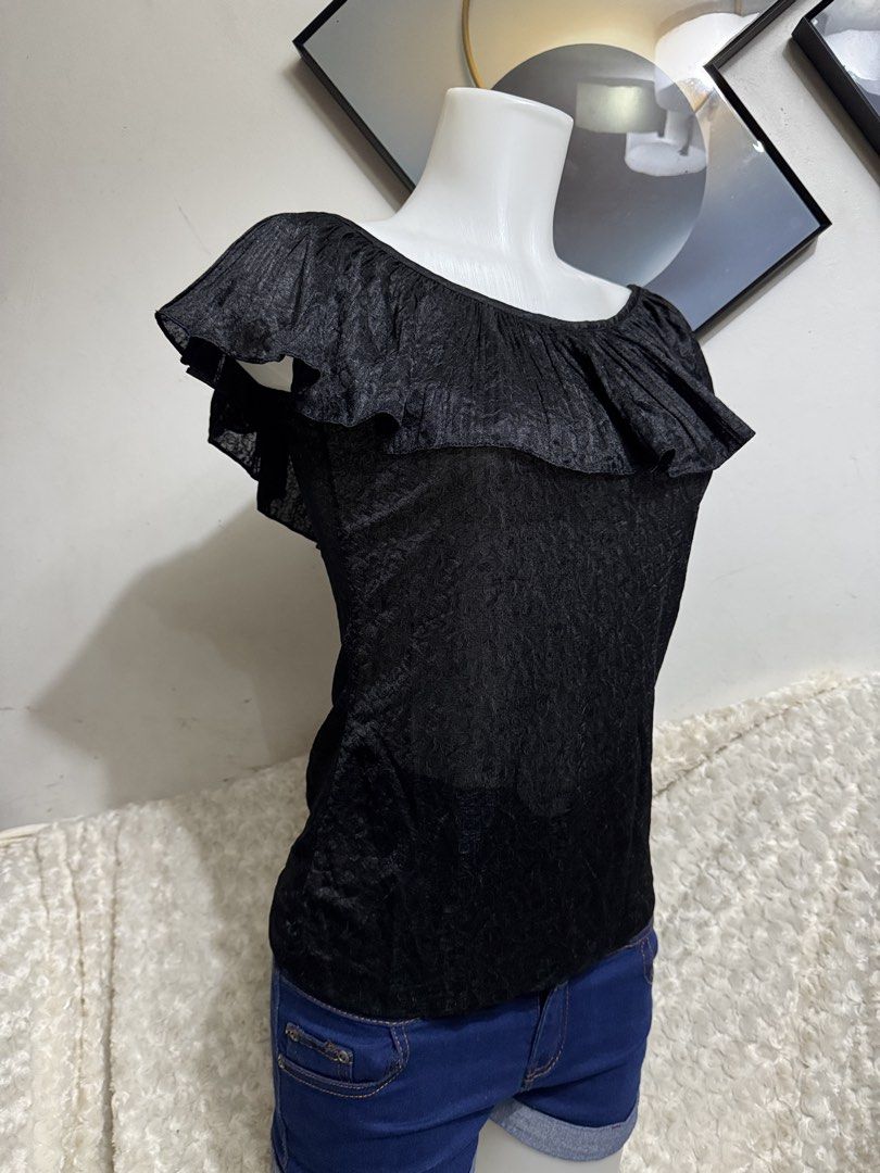 Black Off-Shoulder Ruffle Top Blouse (Category: Blouses) located in Marikina City. Submitted by lorradel (Listing ID 1467508971, Image 2). Description: - fits S-M - Color: Black - Style: Off-shoulder top with ruffled collar - Sleeves: Short flutter sleeves - Fabric: Textured and slightly sheer - Styling: Great to pair with denim shorts or jeans for casual days - MAY HAVE some washable stains (hindi maiiwasan) needs washing; had been stored - mann