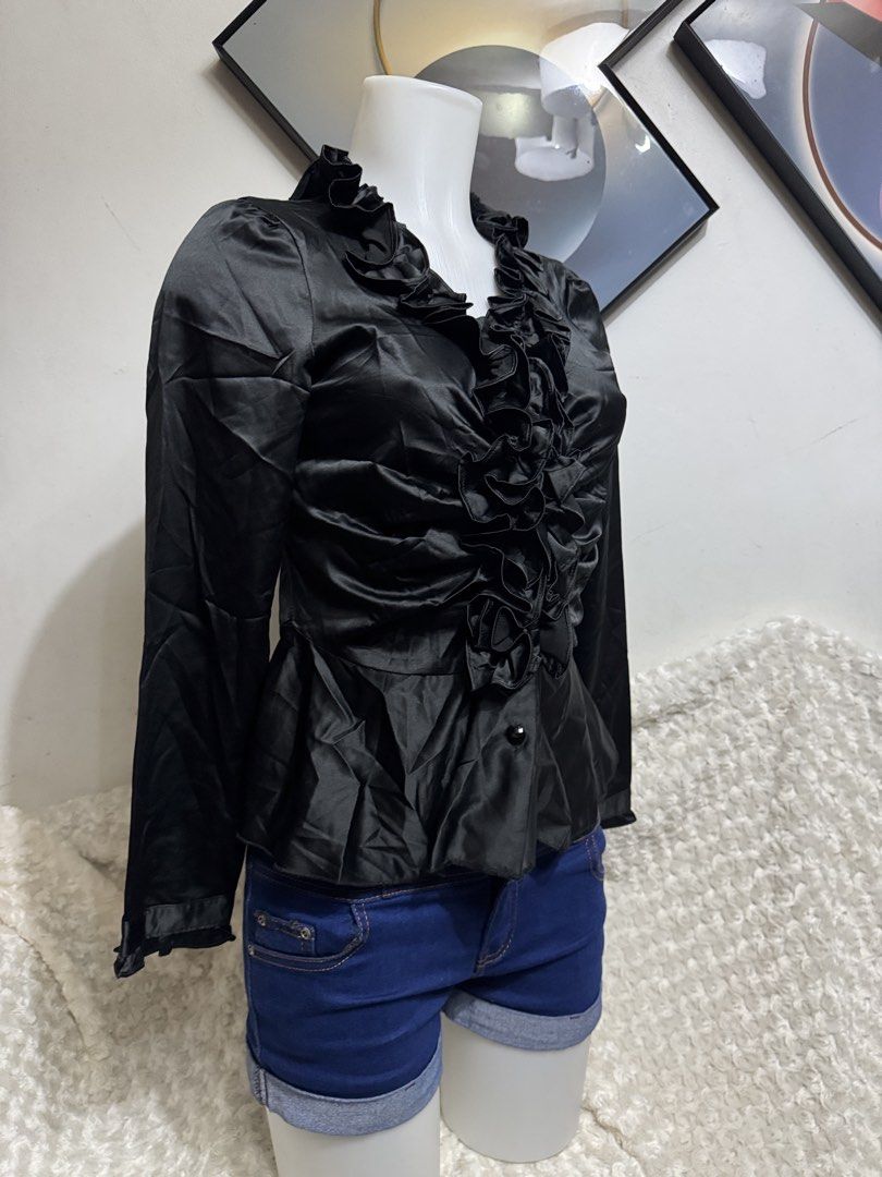 Black Satin Ruffle Front Long Sleeve Blouse (Category: Blouses) located in Marikina City. Submitted by lorradel (Listing ID 1467513734, Image 2). Description: - Color: Elegant Black - Material: Smooth satin with subtle sheen - Design: Dramatic ruffle trim along the front placket and neckline - Fit: Fitted bodice with a stylish flared peplum hem - Details: Long sleeves and hidden button closure - Condition: Excellent / Ready to wear - Perfect for: