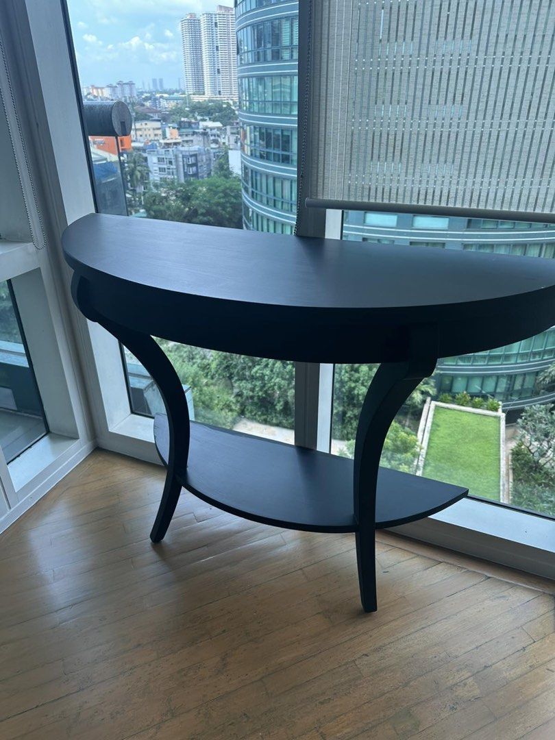 Black Semicircular Console Table Hallway Table (Category: Tables & Sets) located in Makati City. Submitted by goldenrabbit_605125 (Listing ID 1467396196, Image 1). Description: - Sleek black half-moon console table - Elegant curved legs and smooth surface - Sturdy build with clean lines - Neutral color matches any home decor - Ideal for entryways or living room corners 106cmx51cmx26cm (HxLxD) Pick up Rockwell Makati.