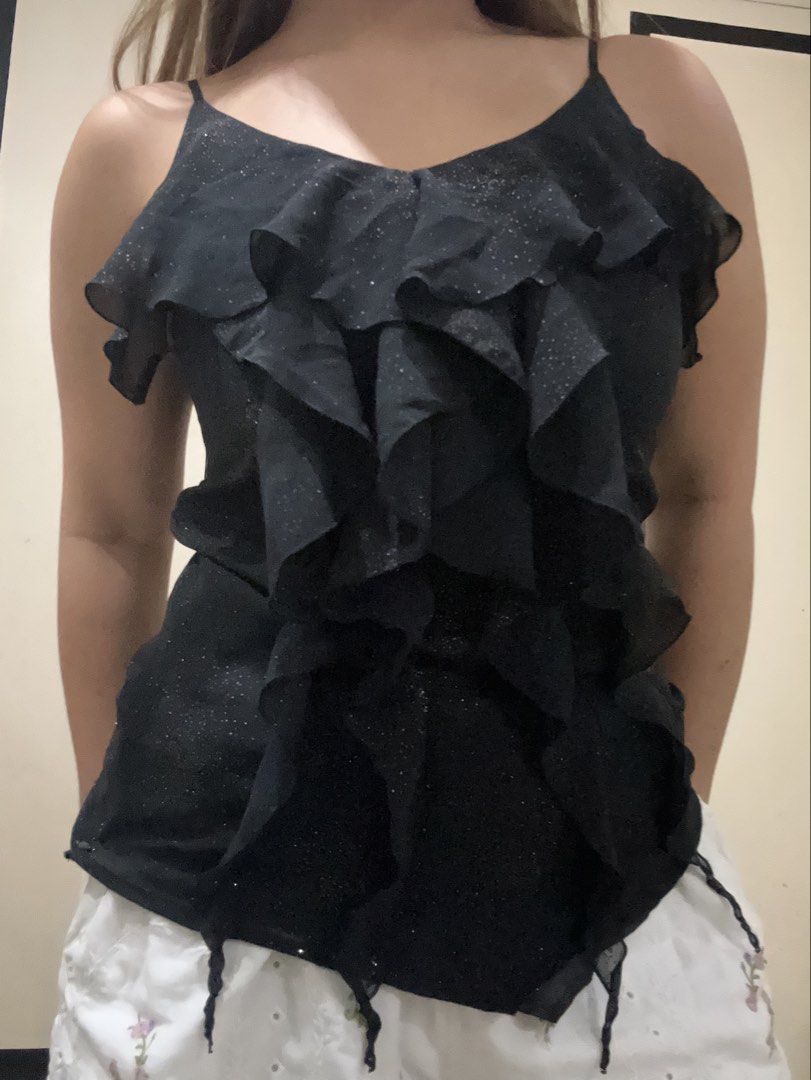 Black Shimmer Ruffle Camisole Tank Top (Category: Sleeveless) located in Cavite. Submitted by lj.collection (Listing ID 1467412156, Image 1). Description: ✦ Best fits xs-s ✦ Got this on an ig shop for ₱290 ✦ worn once only but no flaws ✦ details: black with all-over sparkly glitter details, layered front ruffle with thin spaghetti straps + zipper on side Light, sheer fabric ideal for nights out ✦ MOP: Gcash, Maya, Maribank, BDO ✦ MOD: J&T, Lalamo