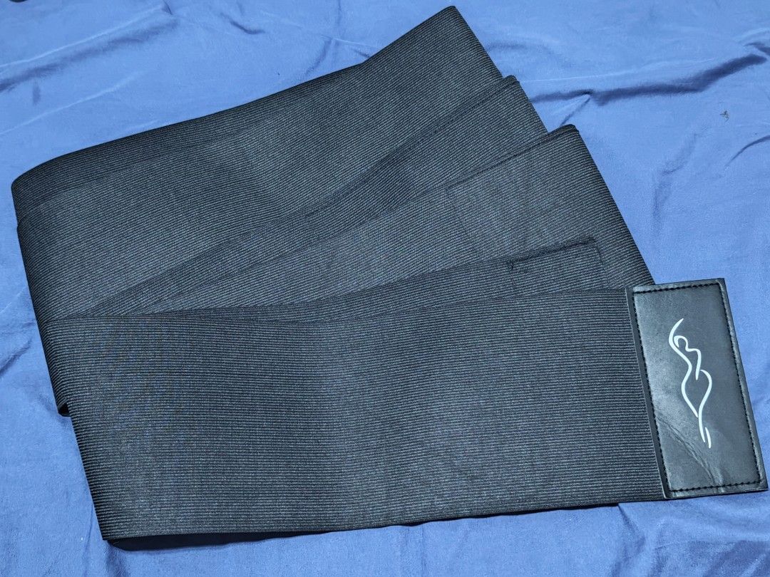 Black Snatch Band Waist Trainer Wrap (Category: Undergarments & Loungewear) located in Pasay City. Submitted by clotheslinemanila (Listing ID 1467556158, Image 1). Description: - Color: Black - Material: Stretchy ribbed fabric with logo patch - Function: Provides extra support and compression for workouts or daily wear - Design: Long enough to wrap multiple times around the midsection - Closure: Strong hook and loop attachment points for a secure