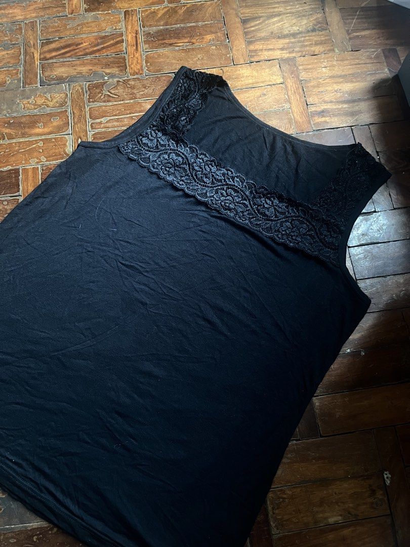 Black tank top with lace trim size medium (Category: Sleeveless) located in Mandaluyong City. Submitted by copthatgirl (Listing ID 1467478546, Image 2). Description: - Color: Black - Style: Sleeveless top with square neckline - Detail: Charming floral lace trim on upper chest and straps - Material: Soft stretch cotton for all-day comfort - Versatility: Essential basic piece that pairs effortlessly with jeans or skirts.