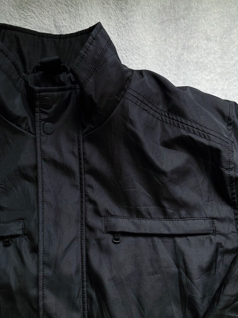Winter utility jacket (Category: Coats, Jackets and Outerwear) located in Rizal. Submitted by sheeraay (Listing ID 1467451352, Image 3). Description: - Color: Black - Material: Durable, heavy-duty nylon - Closure: Heavy-duty zip plus snap button storm flap - Collar: Stand-up design to block the wind - Pockets: Multiple zippered chest pockets and lower flap pockets.