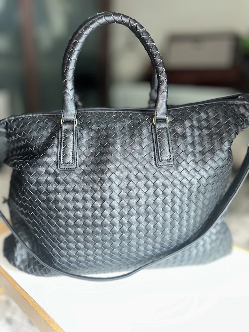 Black Woven Tote Bag with Shoulder Strap (Category: Tote Bags) located in Mandaluyong City. Submitted by TheWeekendProject (Listing ID 1467409295, Image 2). Description: - Stylish black woven tote bag - Features braided handles - Includes a detachable shoulder strap - Secure zipper closure - Intricate weave pattern - Elegant brass-toned hardware - Ample interior space - Perfect for travel or everyday use.