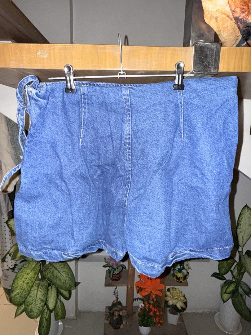 Blue Denim Wrap Skort with Side Tie (Category: Skirts) located in Manila. Submitted by clalala.fire (Listing ID 1467527051, Image 2). Description: - Color: Medium blue - Style: Denim wrap skirt with side tie detail - Length: Mid-length - Details: Contrast stitching and back vertical seam - Fabric: Durable and structured denim - Perfect for: Casual outings, easily paired with plain tees or crop tops.