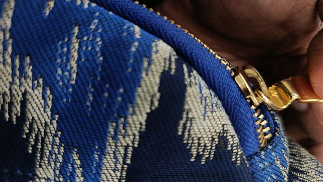 Blue Patterned Crossbody Bag with Gold Hardware (Category: Cross-body Bags) located in Aritao. Submitted by steal.diel (Listing ID 1467473455, Image 2). Description: - Stylish blue and silver patterned crossbody bag - Textured fabric exterior with secure zip closure - Elegant gold tone zipper pull and front orb detail - Comfortable, adjustable blue strap with gold buckle hardware - Roomy interior, perfect for everyday use.
