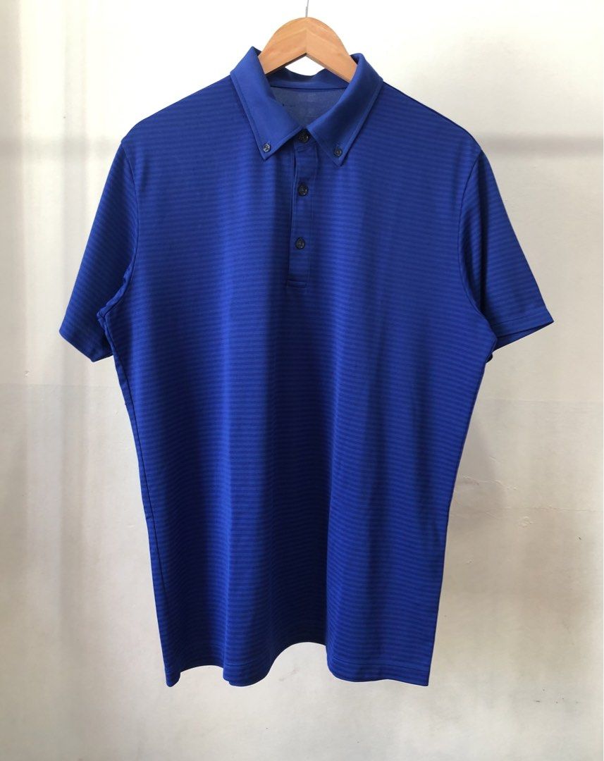 Blue striped button-down polo shirt (Category: Tshirts & Polo Shirts ) located in Manila. Submitted by purewater.2554df (Listing ID 1467383979, Image 1). Description: - Color: Royal blue with subtle horizontal stripes - Collar: Button-down style with dark placket buttons - Fit: Standard fit with short sleeves - Fabric: Clean, stretchable material for all-day comfort - Versatility: Great for casual everyday wear or golf days.