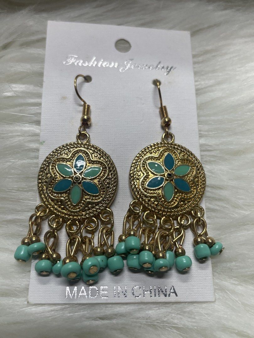 Boho Gold and Turquoise Flower Drop Earrings (Category: Earrings) located in San Juan City. Submitted by redrosierose (Listing ID 1467474998, Image 1). Description: - Condition: Brand new, never used, mounted on original display card - Design: Gold-tone drop earrings with intricate round metal frames - Details: Center teal and turquoise enamel flower design with matching dangling beads - Closure: Fishhook style for easy wear - Perfect for daily w