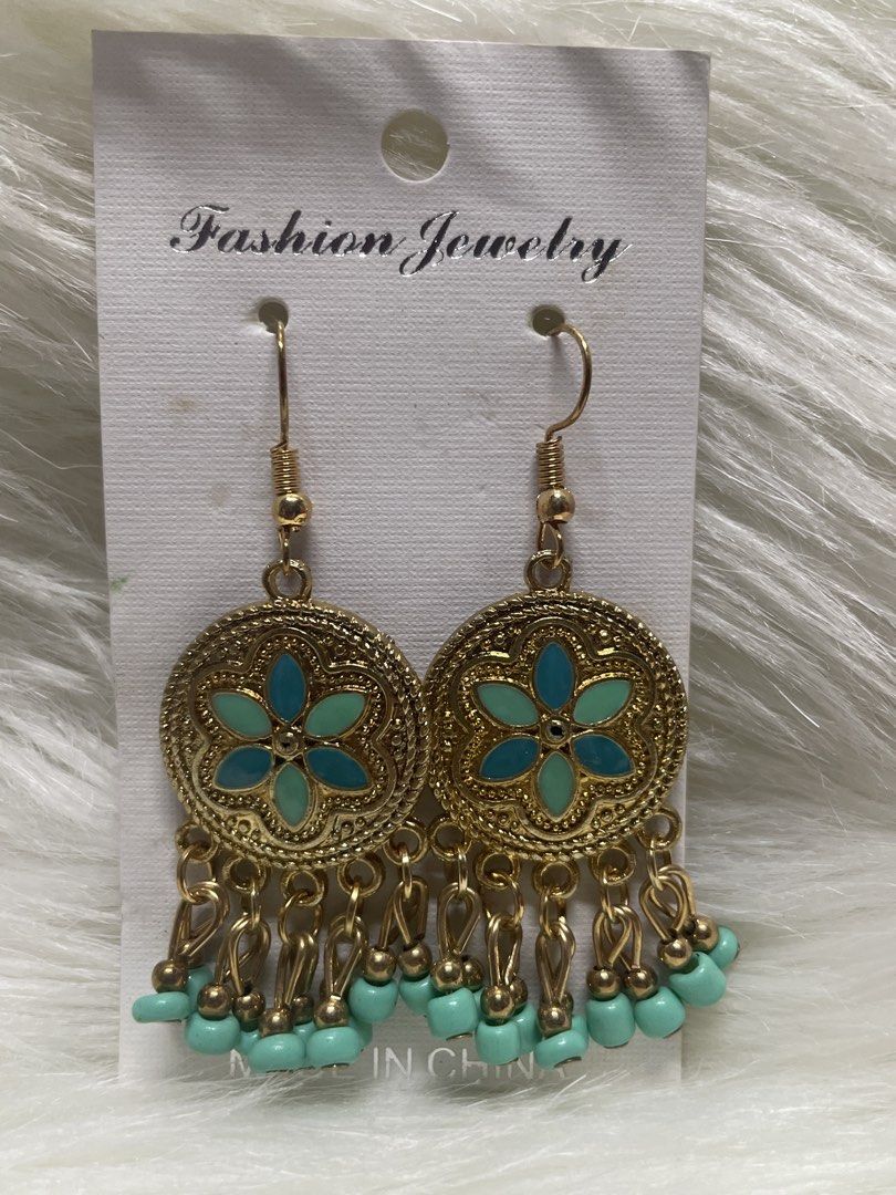 Boho Gold and Turquoise Flower Drop Earrings (Category: Earrings) located in San Juan City. Submitted by redrosierose (Listing ID 1467474998, Image 2). Description: - Condition: Brand new, never used, mounted on original display card - Design: Gold-tone drop earrings with intricate round metal frames - Details: Center teal and turquoise enamel flower design with matching dangling beads - Closure: Fishhook style for easy wear - Perfect for daily w