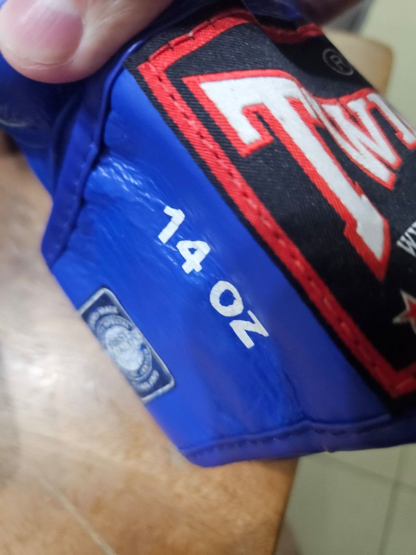 Boxing Gloves 14 oz Blue (Category: Combat Sports) located in Mandaluyong City. Submitted by reyerayo (Listing ID 1467494908, Image 2). Description: - Brand: Twins Special - Color: Blue - Size: 14 oz (Standard) - Material: Genuine leather - Closure: Hook and loop wrist straps with branded logo patches - Style: Classic Muay Thai - Use: Ideal for sparring and heavy bag work - Condition: Ready for training with solid wrist support.