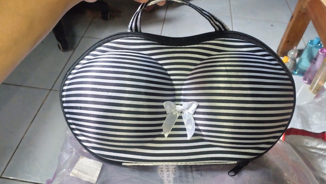 Bra Storage Bag (Category: Purses & Pouches) located in Valenzuela. Submitted by diane.35 (Listing ID 1467393264, Image 1). Description: Black and white striped storage case designed specifically for bras and undergarments. Molded cups help maintain shape during travel or daily storage. Cute white ribbon accent on the front. Sturdy zipper closure all around with a top handle for easy carrying. Keeps your intimates organized and protected..