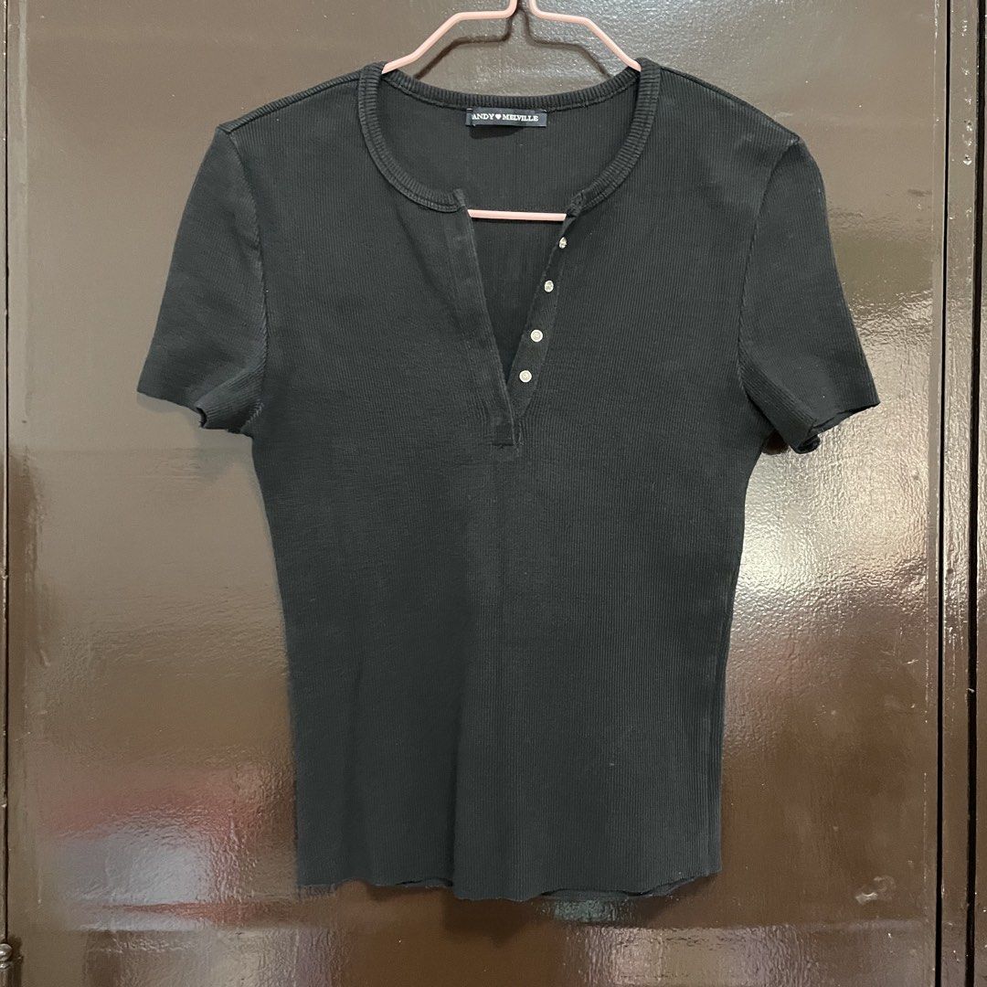 Brandy Melville Black Ribbed Button-Up Top (Category: Shirts) located in Pasay City. Submitted by lovedbyzea (Listing ID 1467528382, Image 1). Description: - black in actual, not faded - Brand: Brandy Melville - Style: Black ribbed short-sleeve top with scoop neckline - Details: Split placket with silver-tone snap buttons down the front - Material: Stretchy, comfortable cotton rib fabric - Versatility: Essential basic piece that pairs easily with
