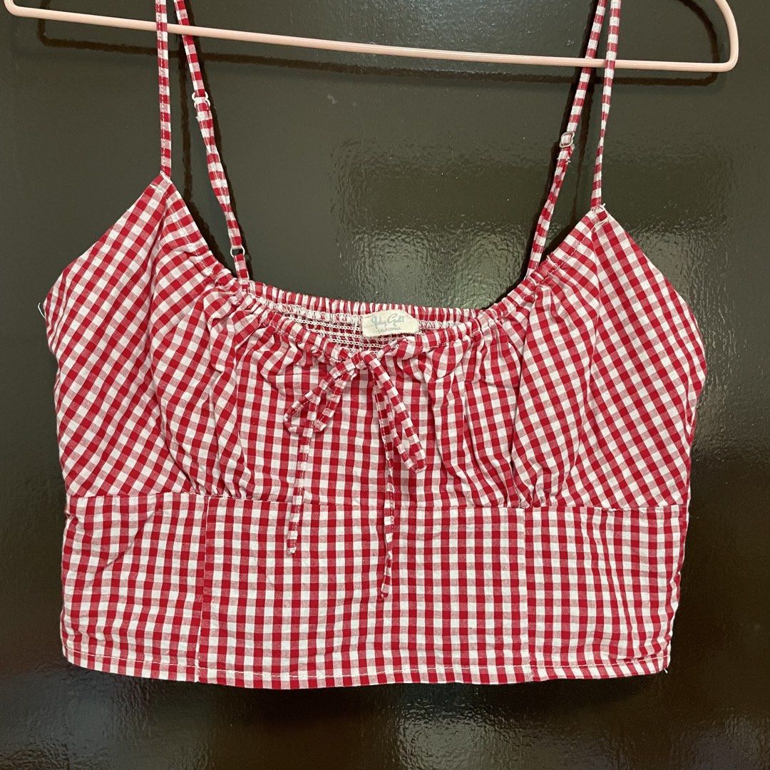 Brandy Melville Red Gingham Crop Top (Category: Sleeveless) located in Pasay City. Submitted by lovedbyzea (Listing ID 1467529869, Image 2). Description: - Brand: Brandy Melville - Style: Red and white gingham crop top with picnic vibe - Details: Sweetheart neckline with front tie bow - Fit: Adjustable spaghetti straps and stretchy smocked back panel.