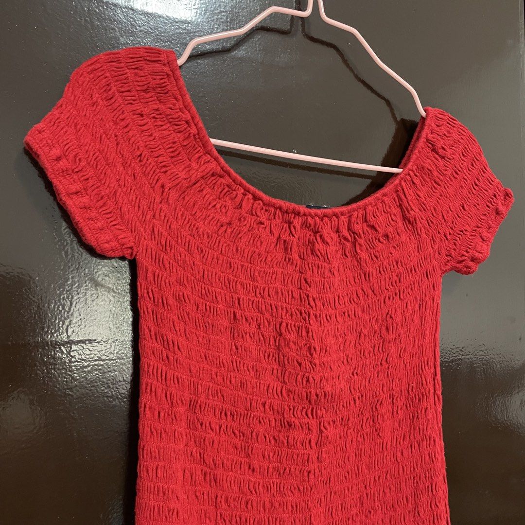Brandy Melville Red Smocked Off-Shoulder Top (Category: Blouses) located in Pasay City. Submitted by lovedbyzea (Listing ID 1467530274, Image 2). Description: - Brand: Brandy Melville - Condition: Brand new with tag attached - Color: Vibrant cherry red - Fit: Super stretchy smocked texture, fits various body shapes nicely - Style: Short sleeves, off-shoulder neckline, crop top - Pairing: Easy to style with high-waisted jeans or skirts.