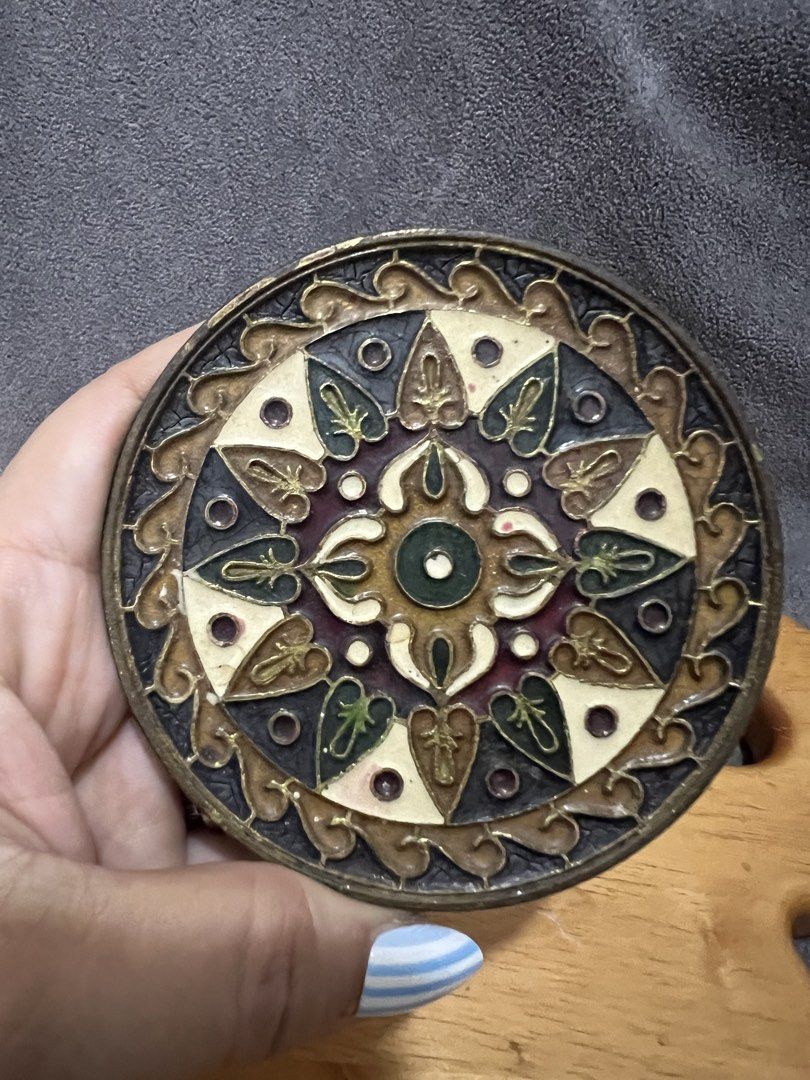 Brass Greek Hand Made Byzantine Mosaic Enamel Solid Brass Plaque (Category: Wall Decor) located in Las Pinas. Submitted by maple0305 (Listing ID 1467400882, Image 1). Description: - Material: Solid brass with intricate enamel work - Design: Byzantine mosaic featuring geometric and floral patterns in dark tones, white, and gold accents - Origin: Hand made in Greece, export quality - Features: Includes a triangle hanging hook mounted on the rear si