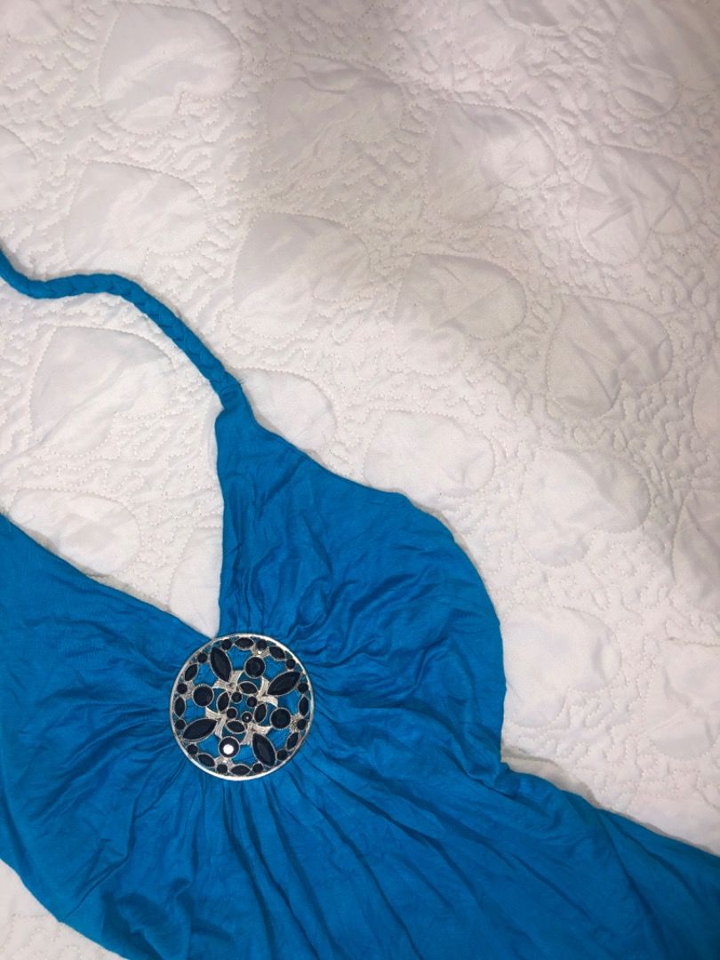 Bright Blue Halter Top With Rhinestone Medallion (Category: Sleeveless) located in Davao. Submitted by christ07_fox (Listing ID 1467571025, Image 2). Description: - Color: Vibrant blue - Design: Sleeveless halter style with braided self-tie neck straps - Centerpiece: Large ornate circular medallion with dark stones and silver metalwork - Fit: Body-hugging silhouette with flattering slight ruching - Material: Soft and comfortable stretch fabric - 