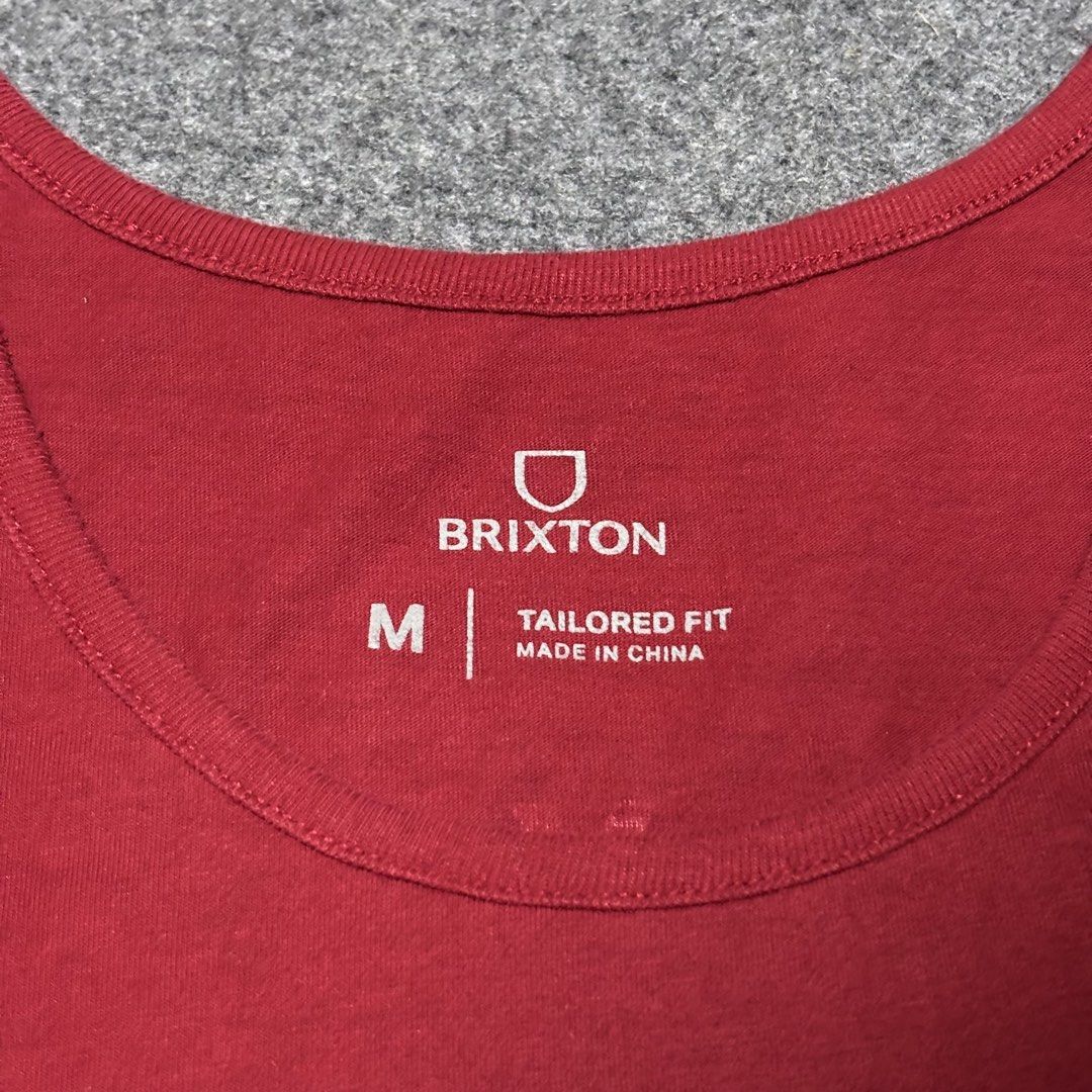 Brixton Red Tailored Fit Tank Top Size M (Category: Tshirts & Polo Shirts ) located in Cebu City. Submitted by andrewvivar29 (Listing ID 1467442439, Image 3). Description: - Brand: Brixton - Color: Rich Red - Size: Medium (Tailored fit) - Design: Small chest logo on front, large graphic on back - Style: Crew neck, sleeveless - Material: 60% Cotton, 40% Polyester (lightweight and comfortable) - Condition: Clean inside and out.