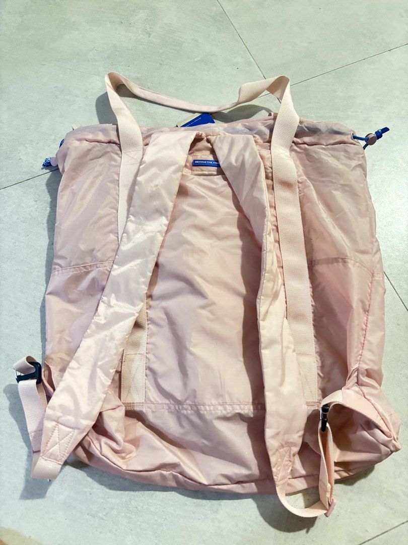 BTV Parapack 002 in light pink (Category: Backpacks) located in Manila. Submitted by nicoleaaa (Listing ID 1467448926, Image 3). Description: - Brand: Beyond The Vines - Color: Light pink nylon with blue cord details (i just have bad lighting at home) - Condition: with original store tags attached; used twice - Features: Dual top carry handles, adjustable shoulder straps, front mesh pocket with branded patch - Closure & Storage: Drawstring and zi