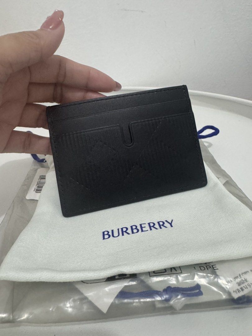 Burberry Black Sandon E5L Card Holder (Category: Luxury Bags & Wallets) located in Bulacan. Submitted by czfullcart (Listing ID 1467572684, Image 2). Description: - Brand: Burberry (Sandon E5L Card Holder) - Color: Classic Black with signature embossed check pattern - Design: Multiple card slots on both sides with a compact, slim profile - Condition: Brand new with tags, original dust bag, and protective plastic packaging - Perfect for: Minimalis