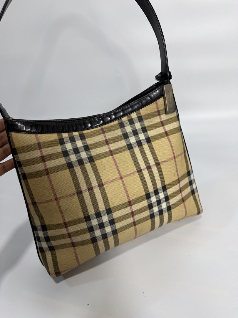 Burberry London Check Shoulder Bag (Category: Luxury Bags & Wallets) located in Dasmarinas. Submitted by arjalaph (Listing ID 1467428679, Image 2). Description: - Authentic classic Burberry check canvas shoulder bag - Premium black leather trim and single strap - Sleek silver-tone hardware - Secure top zip and magnetic snap closure - Black monogram fabric lining with interior zip pocket and metal logo plaque - Crafted in Italy - Perfect for daily