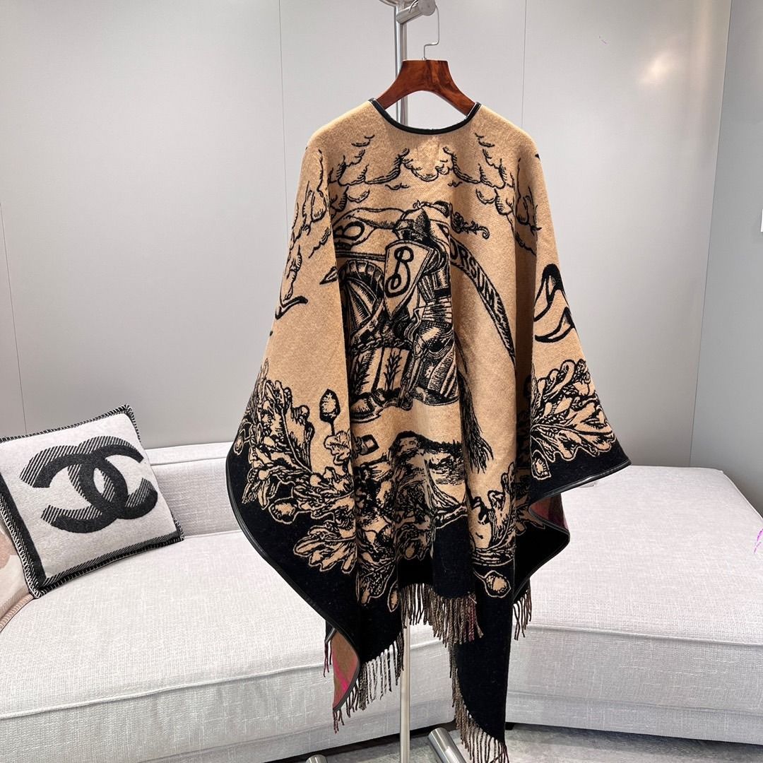 Burberry Reversible Cashmere Cape (Category: Luxury Apparel) located in Manila. Submitted by immeljanpi09460 (Listing ID 1467435170, Image 2). Description: - Brand: Burberry (Made in Scotland) - Material: 100% Cashmere with black leather piping - Condition: Brand new, never worn - Design: Reversible classic beige, black, and brown colorway featuring horse knight design, lettering, oak leaf graphics, and fringe trim - Inclusions: Original tags, Bu