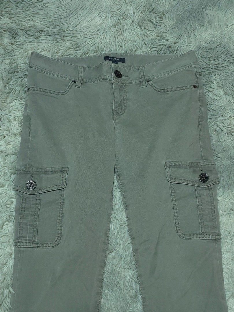 Burberry Slim Fit Cargo Pants (Category: Joggers) located in Abulug. Submitted by humanwhosellthings (Listing ID 1467366380, Image 3). Description: BURBERRY Womens Cargo Pants ✅Excellent Condition ✅Issue: none ▫️Waist Size: 31 ▫️Length: 38 Mid-rise fit with button closure and belt loops. Utility side pockets on both legs with button flaps. Two back pockets featuring branded buttons and a leather Burberry patch on the waistband. Slim fit, versatil