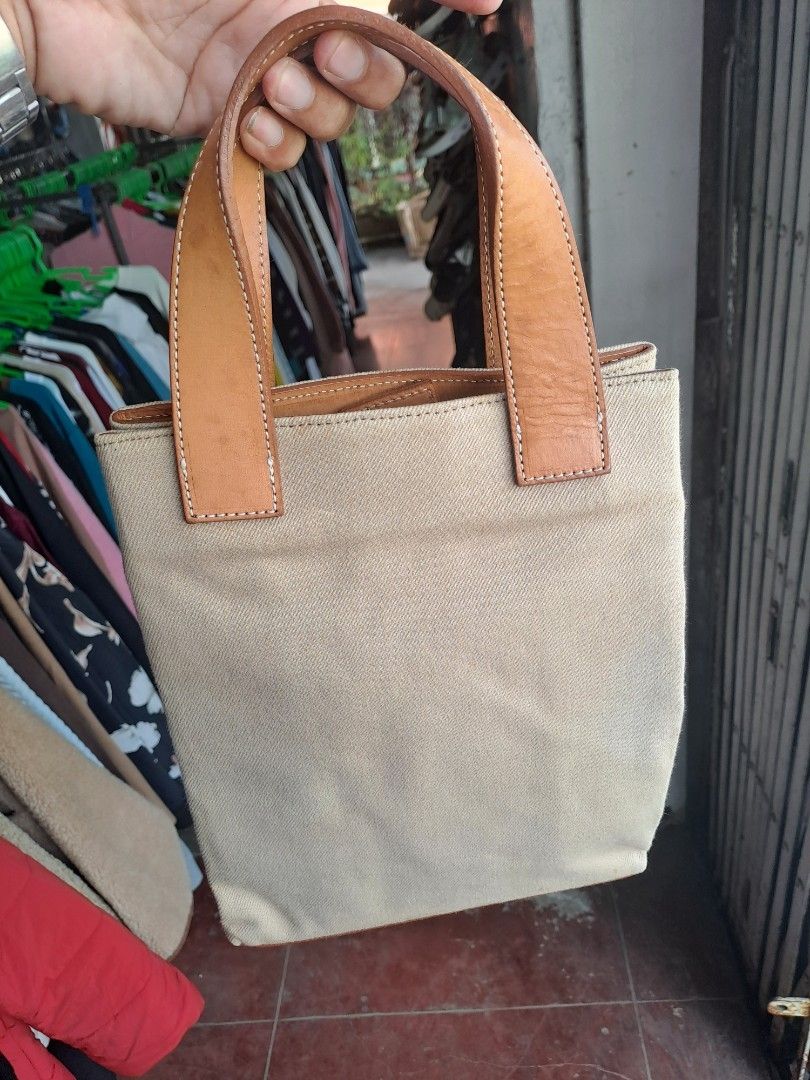 Burberrys Blue Label Canvas Tote Bag (Category: Tote Bags) located in Puerto Princesa. Submitted by jercksthriftph (Listing ID 1467372619, Image 2). Description: - Authentic Burberrys Blue Label tote bag - Crafted from durable beige canvas with leather handles and trim - Classic check pattern panel on the front with a leather brand patch - Double leather top handles for comfortable carrying - Clean interior structure with a sturdy base - Compact 