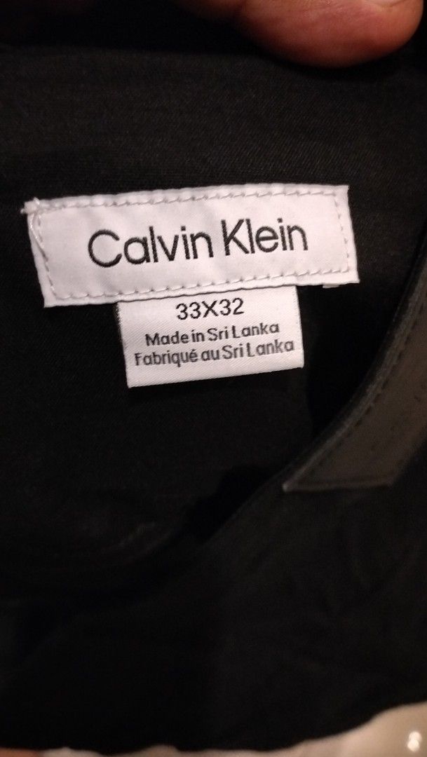 Calvin Klein Black Pants Size 33X32 (Category: Jeans) located in Angeles City. Submitted by mightywhale_13072f (Listing ID 1467411550, Image 3). Description: - Brand: Calvin Klein - Color: Classic Black - Size: 33x32 - Fit: Standard fit, versatile for daily wear or casual office settings - Details: Clean minimalist design with a subtle leather brand patch on the back waistband - Origin: Made in Sri Lanka.