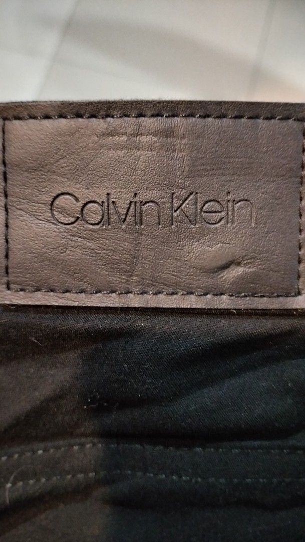 Calvin Klein Black Pants Size 33X32 (Category: Jeans) located in Angeles City. Submitted by mightywhale_13072f (Listing ID 1467411550, Image 1). Description: - Brand: Calvin Klein - Color: Classic Black - Size: 33x32 - Fit: Standard fit, versatile for daily wear or casual office settings - Details: Clean minimalist design with a subtle leather brand patch on the back waistband - Origin: Made in Sri Lanka.