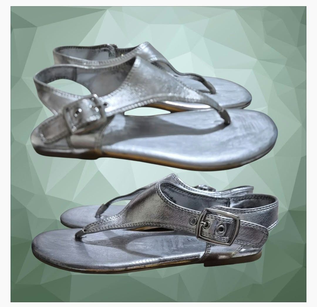 Calvin Klein Silver Thong Sandals (Moraca) (Category: Flats & Sandals) located in Paranaque City. Submitted by calm_youngstore7 (Listing ID 1467564644, Image 2). Description: Calvin Klein Moraca T-Strap Flat Sandals in a metallic silver colorway. Key Features • Design: Minimalist T-strap thong silhouette with a modern wide-set center panel. • Material: Crafted from a smooth, reflective metallic faux-leather upper with detailed perimeter stitching