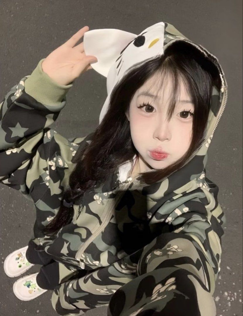 Camo zip-up cat ear hoodie jacket (Category: Coats, Jackets and Outerwear) located in Manila. Submitted by shopshoujang (Listing ID 1467586430, Image 1). Description: - Trendy green and black camouflage all-over print - Full zip-up closure with a cozy fit - Adorable white cat ear hood with detailed face embroidery on the back - Long sleeves finished with ribbed cuffs for extra comfort - Heavy cotton blend material, perfect for staying warm during