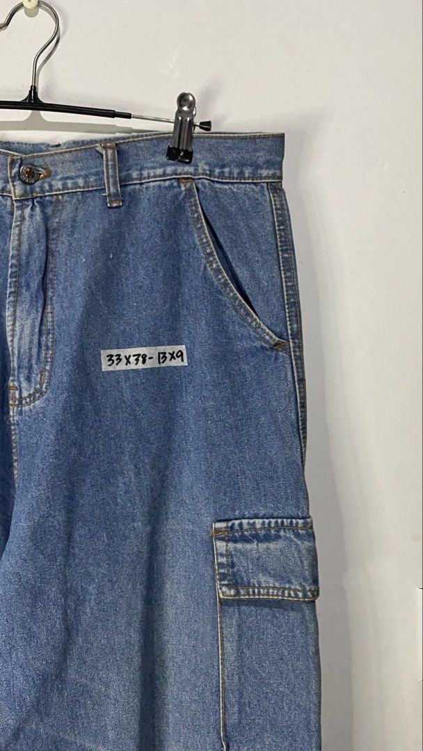 Cargo pants (Category: Jeans) located in Jaen. Submitted by oshimamark58418 (Listing ID 1467405530, Image 3). Description: - Brand: DKNY Jeans - Style: Denim cargo pants / Streetwear - Size: Medium (approx. waist 33) - Color: Medium blue wash - Features: Multiple functional cargo pockets on sides and back, durable denim material - Condition: 7/10 pre-loved condition.