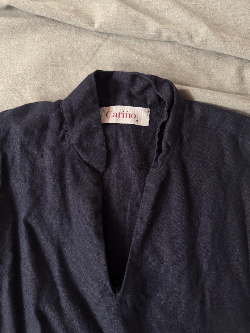 Cariño — Navy blue linen top (Category: Blouses) located in Manila. Submitted by tricia_lara (Listing ID 1467397691, Image 2). Description: Relaxed fit with v-neck neckline :) it’s from their first collection, been sitting in my closet 😅 but still in good condition since cariño has a good quality linen! Shipping via grab/lalamove only 📍Taft Manila .