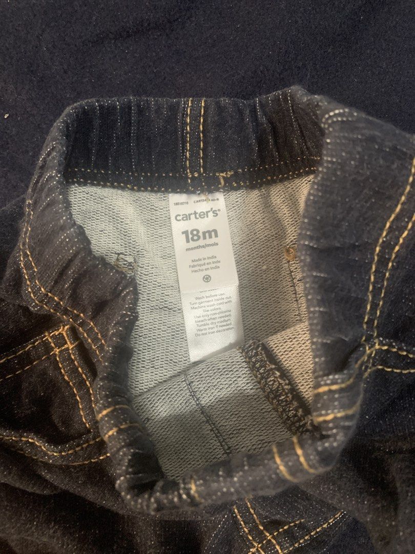 Carter's 18M Denim Pants Jeans (Category: Babies & Kids Fashion) located in Manila. Submitted by closetsunday (Listing ID 1467459736, Image 2). Description: - Brand: Carter's - Size: 18 months - Color: Dark blue wash with contrasting yellow stitching - Comfort: Soft inner material with an easy-dress elastic waistband - Design: Faux front pockets for a classic denim look - Versatility: Great everyday pants, easy to mix and match with various tops.